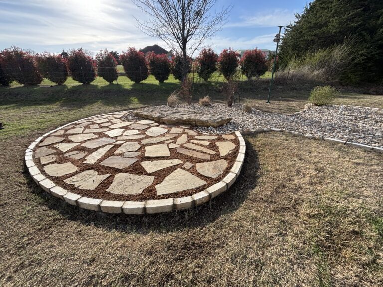 Flagstone patio with cut-stone border built by Barefoot